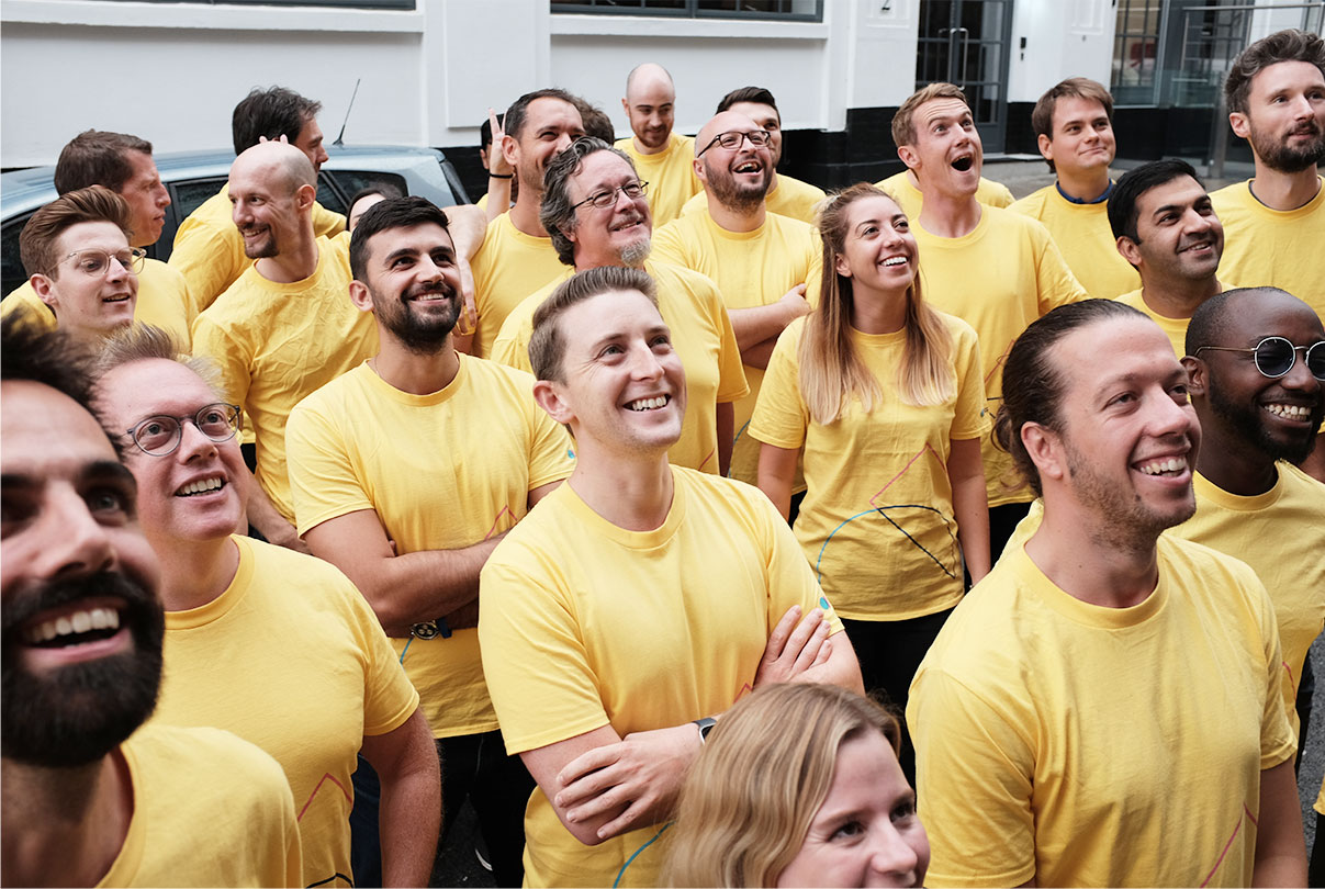 AppyWay Team outside the office in yellow shirts smiling